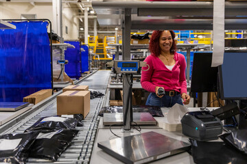 Pretty Online shipping warehouse worker with scanner 