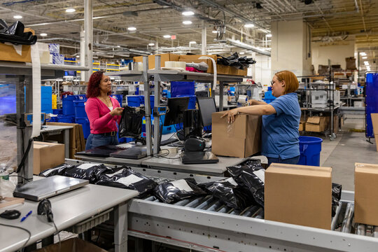 Two workers together at open Interior warehouse 