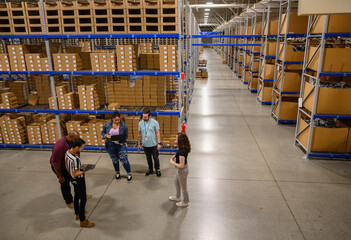 Laptop Meeting at E-Commerce Warehouse Distribution