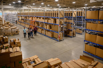Employees Meeting in aisle at warehouse 