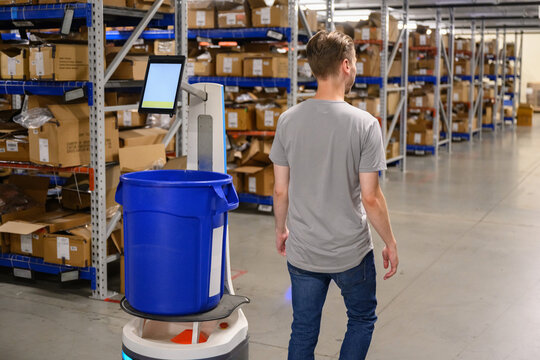 Freight Manager with Robot on floor at Warehouse 