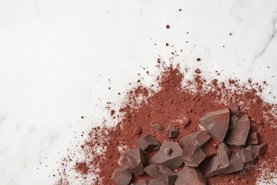 Dark chocolate lying in cocoa powder