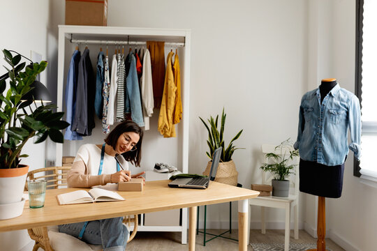 Woman preparing vintage clothing order 