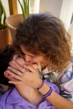 Teen women kissing portrait