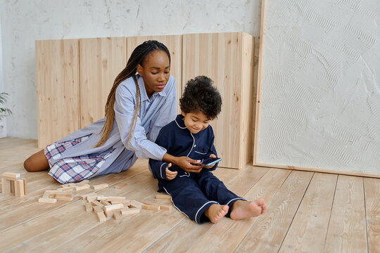 a woman and a child are looking at the phone 