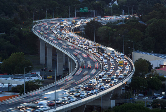 A curved stretch of motorway during rush hour. 