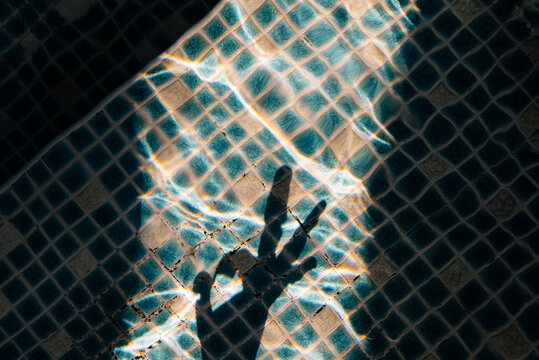 ok sign shadow on water surface in swimming pool