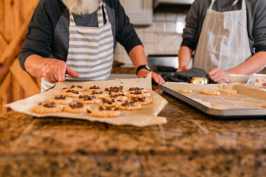 Teenager and grandfather cooking together