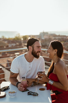 Couple drinking a cocktail in a rooftop bar