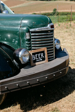 Beer Sign Sitting on Old Truck