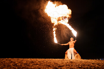 Latin performer breathing with fire