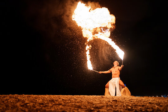 Latin performer breathing with fire