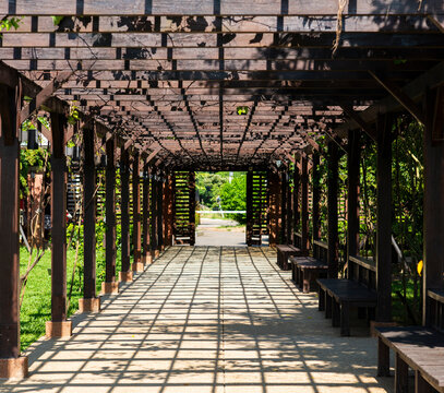 Wooden corridor with shadow in garden