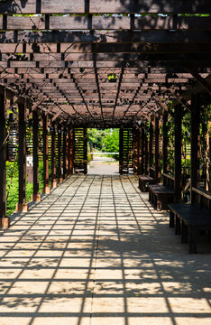 Wooden corridor with shadow in garden