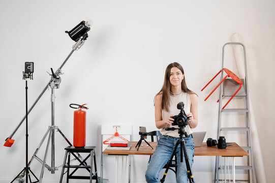 Woman setting up camera in studio