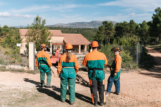 Woodcutters outside house in countryside