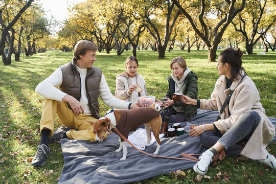 Family sharing sandwiches during picnic
