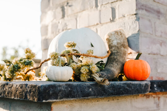 pumpkins  on ledge of outdoor fireplace