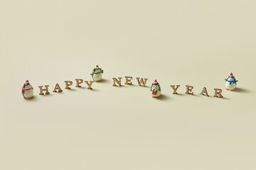 Happy new year message with penguins statuettes