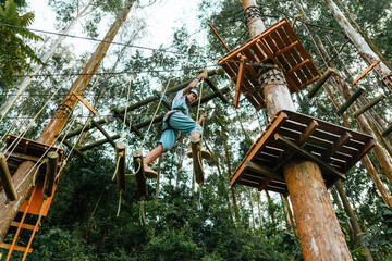 Active woman walking on rope course