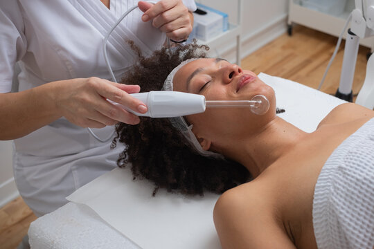 Woman Having Facial Treatment With Electronic Device