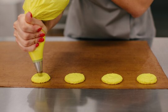 Anonymous woman cooking macarons