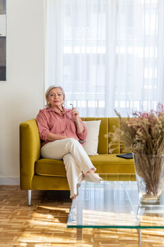 Mature female sitting on settee