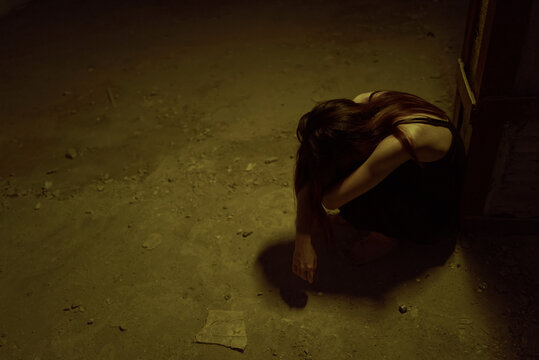 lonely young woman curled up 