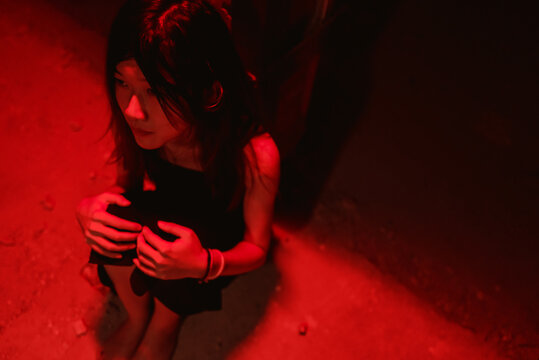 lonely young woman curled up 