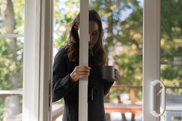 Woman closing screen door