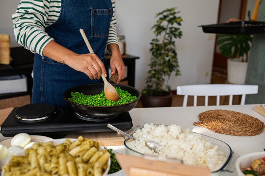 Woman cooking peas