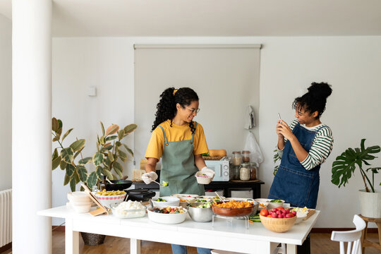 Women having fun preparing lunches take away