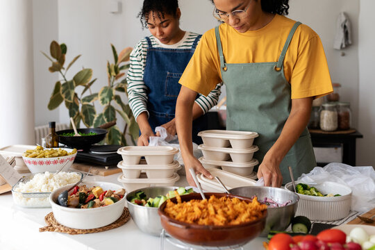 Female cooks preparing lunches to go