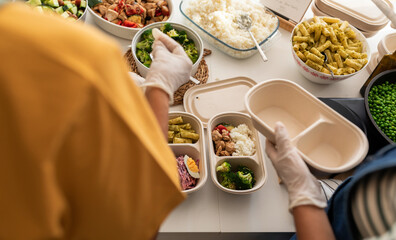 Cooks preparing balanced menus on lunch boxes
