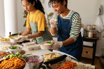 Latin women preparing eco friendly lunch boxes