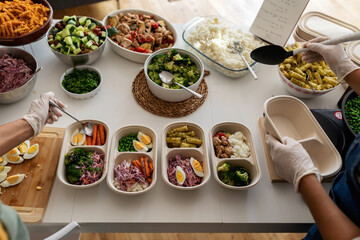 Cooks preparing balanced menus on lunch boxes