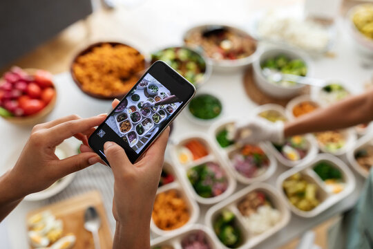 Female taking pics to lunch boxes