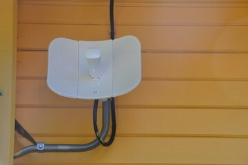 Outdoor router, street access point, coverage WI-FI area repeater. Street router for the Internet hangs on the wall
