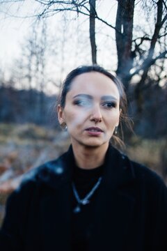 Woman with smoke in front of her face 