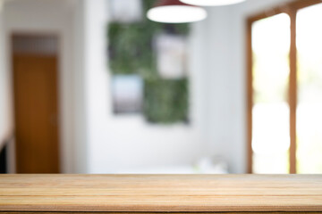 Wooden table with blurred living room background. Copy space for display of product.
