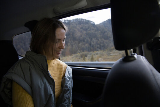 Traveling woman in car in mountains