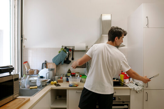 Man prepares to cook in the kitchen