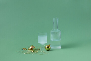 Decanter and glass of water among golden baubles