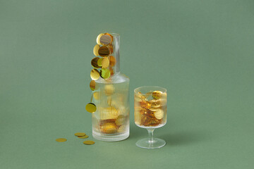 Golden confetti inside glass and decanter
