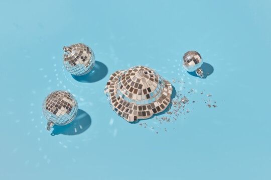 Mirror disco balls on light blue background