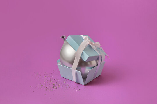 Silver balloon inside small gift box