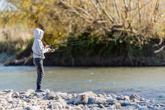 Child fishing in a flowing river
