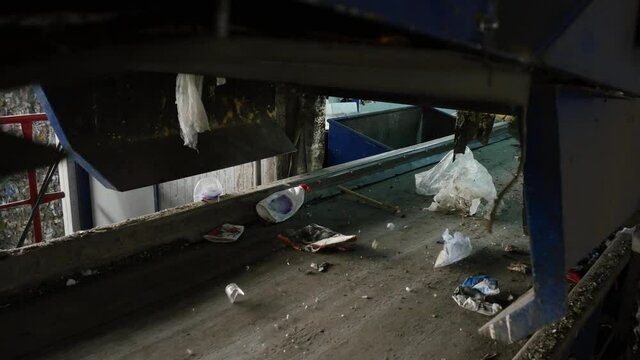 Garbage falling onto a conveyor belt