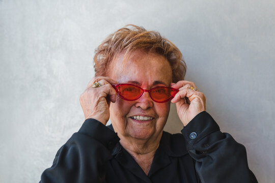 Portrait of a Senior Woman with Red Cool Glasses