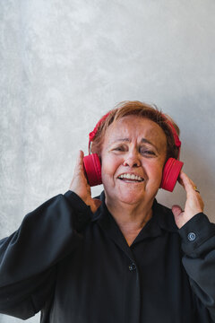 Elderly Woman Singing while Holding Headphones